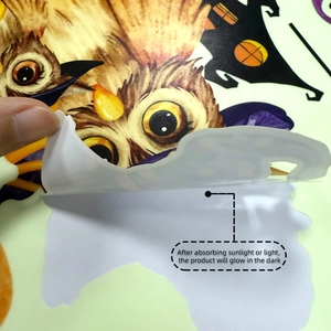 Glow-in-the-dark Halloween wall sticker detail showing luminous adhesive layer on owl decal