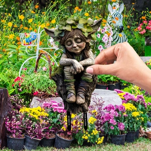 Cute tree elf PVC garden stake decoration with smiling forest spirit on a stump
