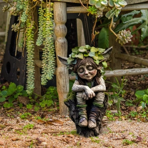 Detail of cute forest spirit garden ornament with leaf crown and stone texture