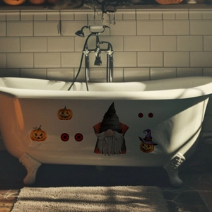 Luminous Halloween gnome and pumpkin stickers displayed on a white bathtub surface