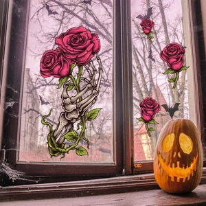 Gothic Halloween window clings featuring skeleton hand holding rose and bats on glass