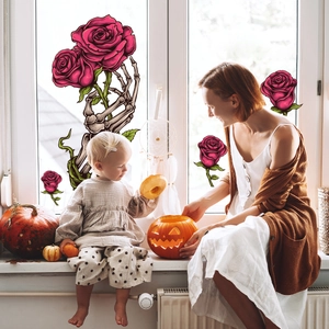Halloween static window cling showing a skeleton hand holding pink roses on a sunny window