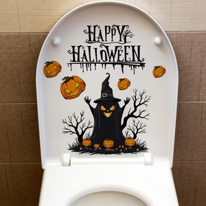 Close-up of Happy Halloween toilet seat decal with ghosts and pumpkins on white cover