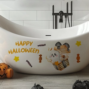 Luminous Halloween decals with ghost and candy motifs applied on a white bathtub side