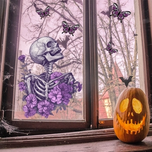Detail of Halloween window clings featuring skulls, purple flowers, and bats for glass