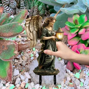 Detail of angel fairy garden stake light with bronze finish and intricate feather wings