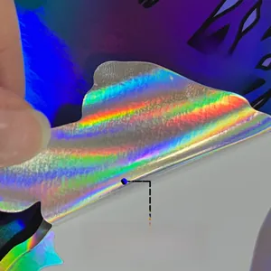 Close-up of holographic laser material showing rainbow color shifts and adhesive backing