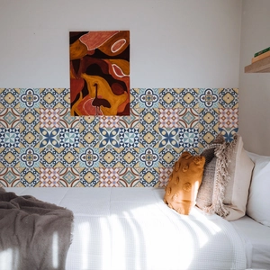 Close-up of retro bohemian tile stickers with geometric patterns on a bedroom wall