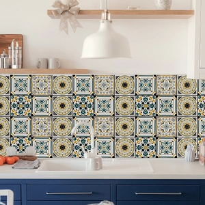 Detailed view of mandala tile stickers on a modern kitchen backsplash with blue cabinets