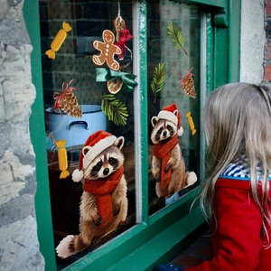 Detailed Christmas raccoon window clings with gingerbread and pinecone festive decorations