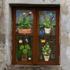 Detail of double-sided vinyl window stickers with potted plants and colorful butterflies