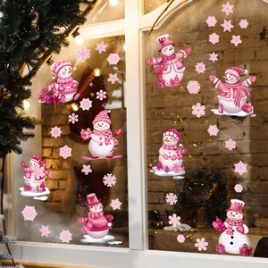 Pink Christmas snowman window decals with snowflakes set on a glass pane background
