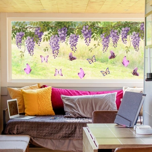 Close-up of wisteria vine and colorful butterfly window clings on a glass window