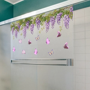 Detail of frosted glass window sticker featuring hanging wisteria and purple butterflies