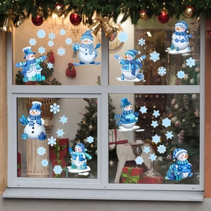 Detailed view of cartoon snowman and blue snowflake static window stickers on glass