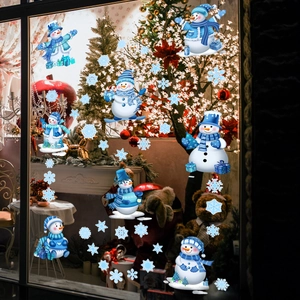 Detailed view of blue snowman and snowflake static stickers on a festive glass window