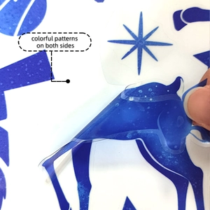 Detail of peeling a double-sided blue elk silhouette window sticker from its backing