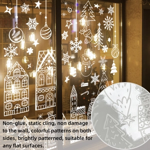 Detail of white Christmas static cling window stickers with snowmen and houses on glass