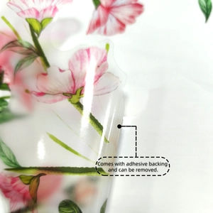 Macro detail of peel-off self-adhesive pink flower wall sticker with removable backing