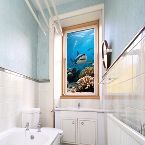 3D ocean window sticker featuring a white shark and coral reef for bathroom decor