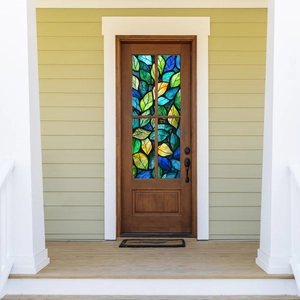 Artistic colorful leaf patterns on static cling window film applied to dark wood door panes