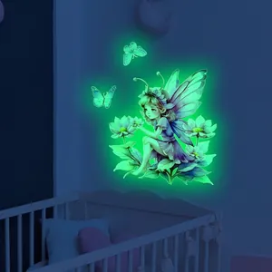 Luminous flower fairy and butterfly wall sticker glowing green in a dark nursery room