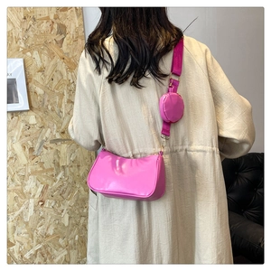 Detail of rose pink baguette bag with matching coin purse and adjustable strap