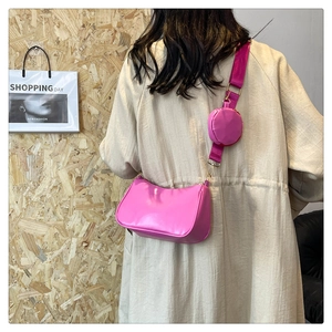 Detail of rose pink crossbody bag with wide strap and detachable round mini coin purse