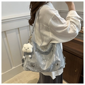 Silver pleated shoulder bag with metal butterfly studs and fluffy white cloud pendant