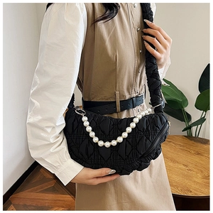 Quilted black cloud shoulder bag featuring a wide strap and elegant pearl chain detail