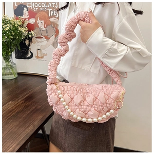 Detailed texture of pink quilted cloud bag with pearl chain and shirred handle detail