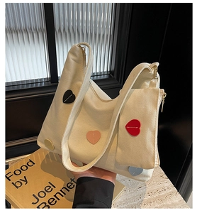 Detail of canvas tote with colorful heart patches and matching small heart pouch