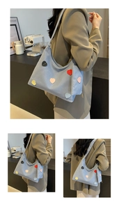 Detail of light blue canvas tote with heart appliques and matching coin purse