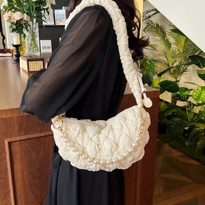 Chic quilted dumpling bag in ivory white featuring pearl chain and pleated shoulder strap