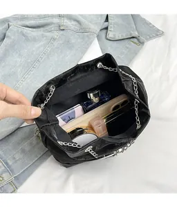 Top view of black bow backpack showing large capacity with makeup and phone inside