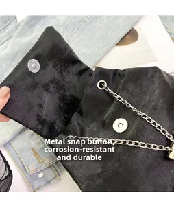 Close-up of durable silver magnetic snap and textured black fabric on bow backpack