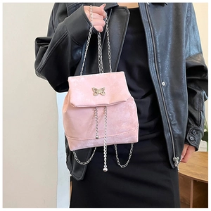 Detail of pink mini backpack with silver butterfly charm and chain shoulder straps