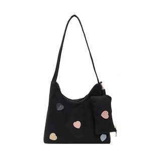 Black canvas tote bag with colorful heart patches and matching small heart coin purse