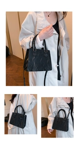 Detailed views of black PU leather bag with wrinkled texture and gold hardware