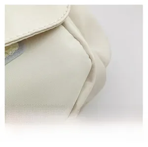 Detailed macro shot of high-quality water-resistant cream fabric with plush decoration