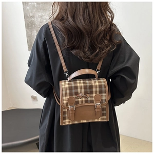 Detailed back view of a retro brown plaid backpack with cute dachshund embroidery