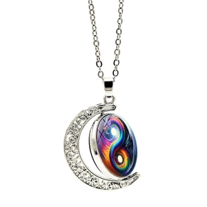 Rotating moon pendant necklace featuring yin yang dragon motif on silver crescent chain