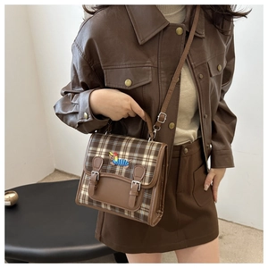 Brown vintage checkered crossbody bag with dog embroidery shown on model for daily use