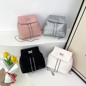 Mini velvet backpacks with bow buckles and chains in pink, silver, black, and white