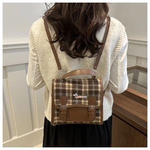 Detail of preppy brown plaid backpack with dachshund embroidery and double strap closure