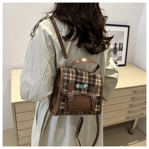 Retro plaid backpack with puppy embroidery shown on model in a cozy indoor setting