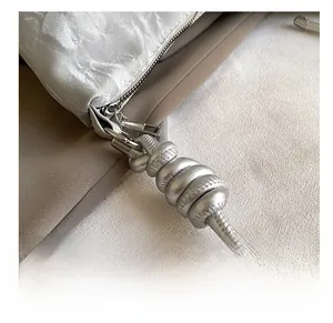 Detail shot of the silver textured fabric underarm bag with high-quality metal zipper