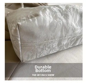 Detail of wear-resistant silver faux leather bag bottom with durable double stitching