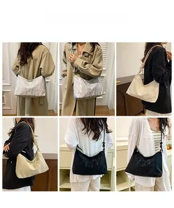 Detailed views of crescent shoulder bags in silver, cream, and black with pleated textures