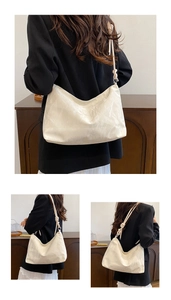 Detail of off-white large capacity hobo bag with knotted shoulder strap for daily use